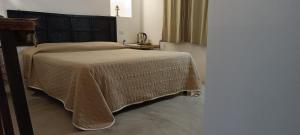 Rúm í herbergi á B&B Sperlonga