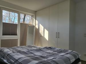 a bedroom with a bed and a large window at Elseblick in Schüttorf