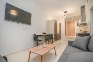 a living room with a couch and a table at Kos Cozy Home in Kos