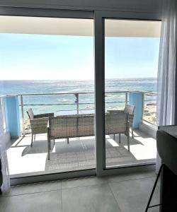 a view of the ocean from the balcony of a condo at Stegna Sea & Sun in Archangelos