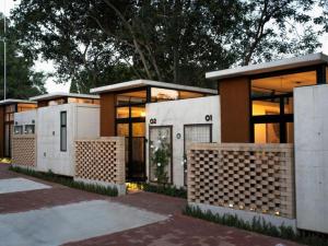 a row of modular homes in front of trees at Brooklyn Blok in Pretoria