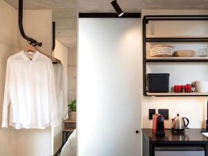 a room with a white shirt hanging on a door at Brooklyn Blok in Pretoria