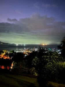a view of a city at night with the ocean at Casa Yacht Club in Ilhabela