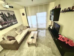 a living room with a couch and a coffee table at Lo Gambussi Deltebre in Deltebre
