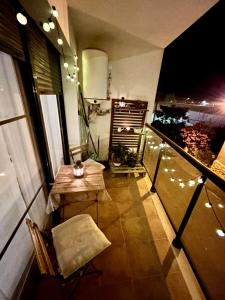 a balcony with a table and a bench and lights at Lo Gambussi Deltebre in Deltebre