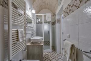 un bagno con lavandino, wc e doccia di Borgo Diaz a Cisternino Altre 37 foto