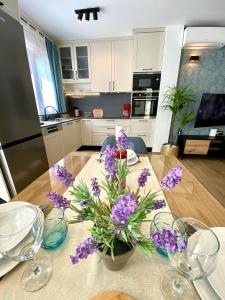 a table with purple flowers on top of it at Luxury house Prestige Split in Split +13 photos