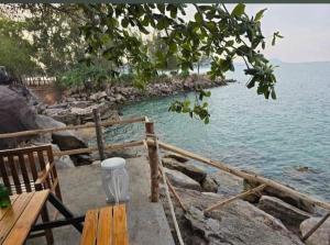 una panchina sulla riva di un corpo d'acqua di An Yen Resort a Phu Quoc