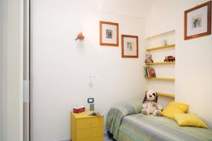 a bedroom with a teddy bear sitting on a bed at Casa Vento di Mare in Ischia