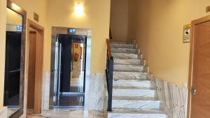 a staircase in a room with a door and a hallway at El Mirador De Limes in Cangas del Narcea