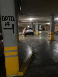 a parking garage with a car parked in it at Cerca de todo en San Jerónimo in Monterrey