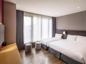 Rúm í herbergi á Ibis Ambassador Myeongdong