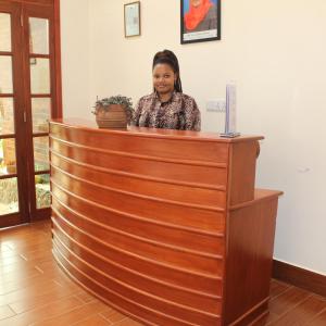 a woman standing behind a counter at at The Little Home in Arusha
