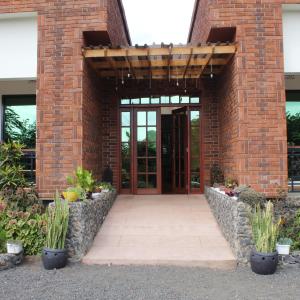 an entrance to a brick building with a door at The Little Home in Arusha