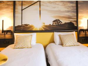 Postel nebo postele na pokoji v ubytování Ibis Styles Clermont-Ferrand République