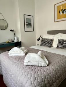 een slaapkamer met een bed met twee handdoeken erop bij Private Double Room with Ensuite, No Breakfast, Truro City Centre in Truro