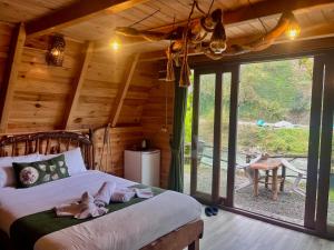 a bedroom with a bed with stuffed animals on it at Yaşam Bungalows Otel in Çamlıhemşin