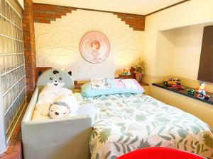 a bedroom with a bed with two teddy bears on it at Ikaho Kids Paradise Hotel - Vacation STAY 56072v in Shibukawa