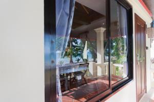a glass window of a house with a table and chairs at Koh Chang Grandview Resort in Ko Chang