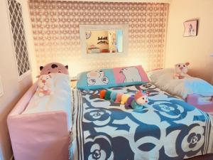 1 dormitorio con 2 camas con animales de peluche en Ikaho Kids Paradise Hotel - Vacation STAY 56430v, en Shibukawa