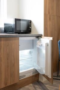 a microwave oven sitting on top of a refrigerator at Marian Resort And Spa in Prestatyn