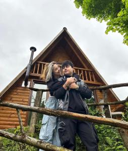 a man and woman standing in front of a tree house at Yaşam Bungalows Otel in Çamlıhemşin