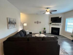 a living room with a couch and a fireplace at Belvedere in Anderson +17 photos