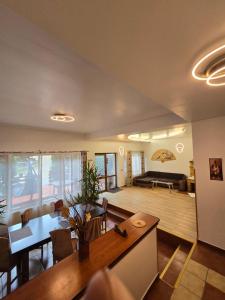 a living room with a table and a dining room at Pensiunea Eliza in Sinaia +72 photos