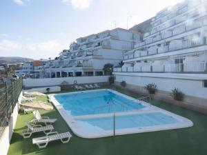 a swimming pool on the roof of a building at Sandra Amadores in Puerto Rico de Gran Canaria