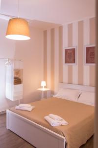 1 dormitorio con 1 cama con 2 toallas en La Casa di Ninì en Agrigento
