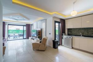 a kitchen with a couch and a chair in a room at Luxury villa Ada Marin in Kusadası