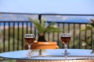 two glasses of wine sitting on a table at Ionian Overlook in Lixouri