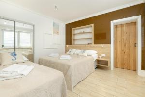 מיטה או מיטות בחדר ב-Dom Gościnny Amber Dziwnów - apartamenty i pokoje