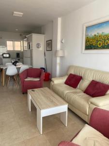 a living room with a couch and a table at Apartamento a pie de playa. in Nerja