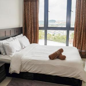 a bed with a teddy bear laying on it at KLIA Airport Homestay 8 in Sepang