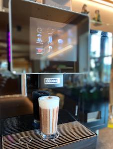 a cup of coffee sitting on top of a counter at Hotel am Wiesenhang - Garni in Bad Kohlgrub