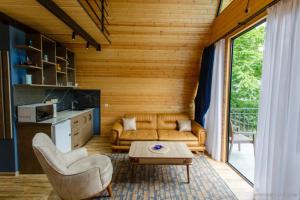 a living room with a couch and a table at Panorama BatumGora in Batumi