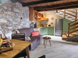 a living room with a couch and a kitchen at Kuća za odmor Ameli in Mošćenička Draga