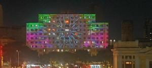 a large building with purple and green lights on it at Apartamento Centro Belo Horizonte in Belo Horizonte