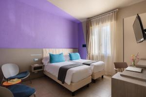 Postel nebo postele na pokoji v ubytování Hotel Nina
