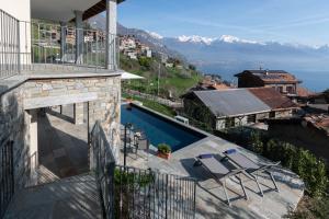a house with a swimming pool and a balcony at VILLA SANT'ANNA by Curtiaffitti in Pianello Del Lario