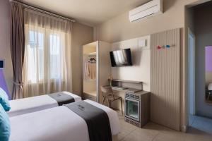 Postel nebo postele na pokoji v ubytování Hotel Nina