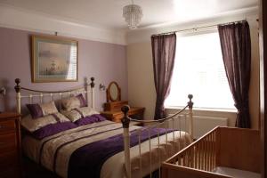 a bedroom with a bed and a window at Helene - Dog Friendly Family Home on Norfolk Coast in Potter Heigham