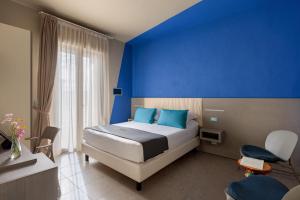 Postel nebo postele na pokoji v ubytování Hotel Nina