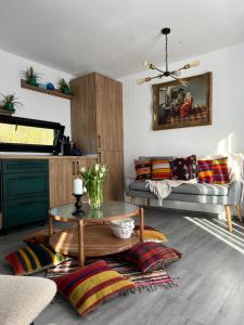 a living room with a couch and a table at Cuibul din livadă in Suduleni +46 photos