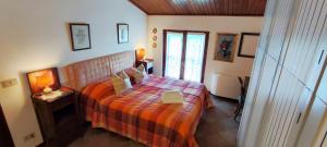 a bedroom with a bed with a orange bedspread at Le Quattro Stagioni in Massa +31 photos