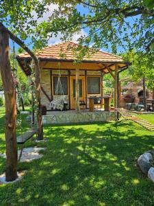 a house with a gazebo in a yard at Drinska Dedovina in Gornja Trešnjica