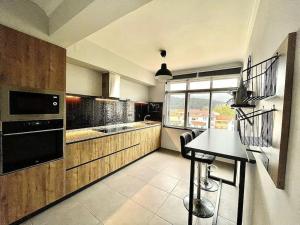 a kitchen with a sink and a stove top oven at Acogedor retiro junto al mar in Cedeira