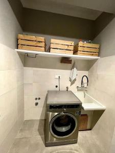 a washing machine in a bathroom with a sink at Acogedor retiro junto al mar in Cedeira +19 photos