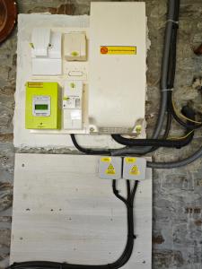 a electrical box with wires andvoltages on a wall at Chambres Les Salles in Beauvoir